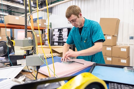 An RIS employee carefully packages an assembly to prepare it for delivery to its final customer.