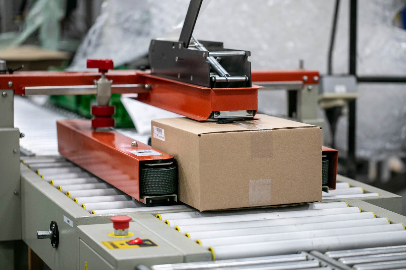A close up of the tape machine at RiverSide Integrated Solutions. Just one part of our final packaging and kitting line.