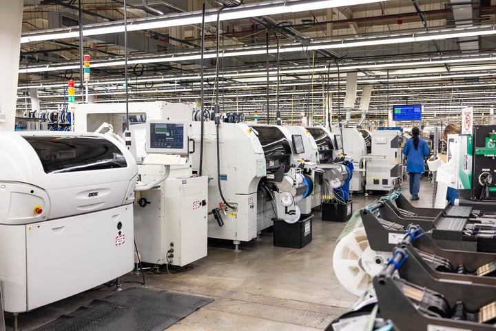 An SMT assembly line at RIS, where PCBAs are placed into loaders at one end and are automatically sorted at the finish.