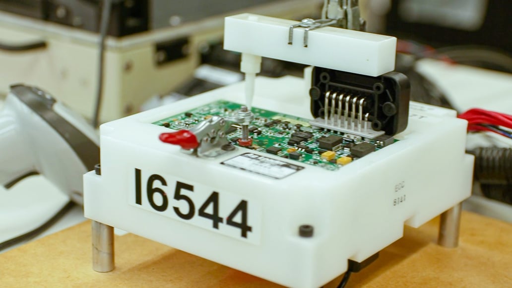 A PCBA at RiverSide Integrated Solutions being tested for proper functionality on a custom-built test fixture.