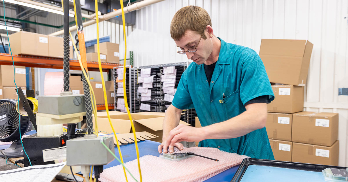 RIS production worker packaging assemblies for fulfillment and distribution.