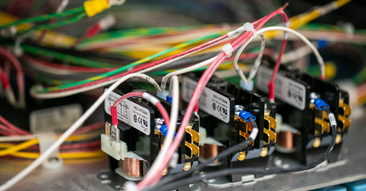 Close up image of a several electronic subassemblies mounted in a larger metal enclosure for a full product.