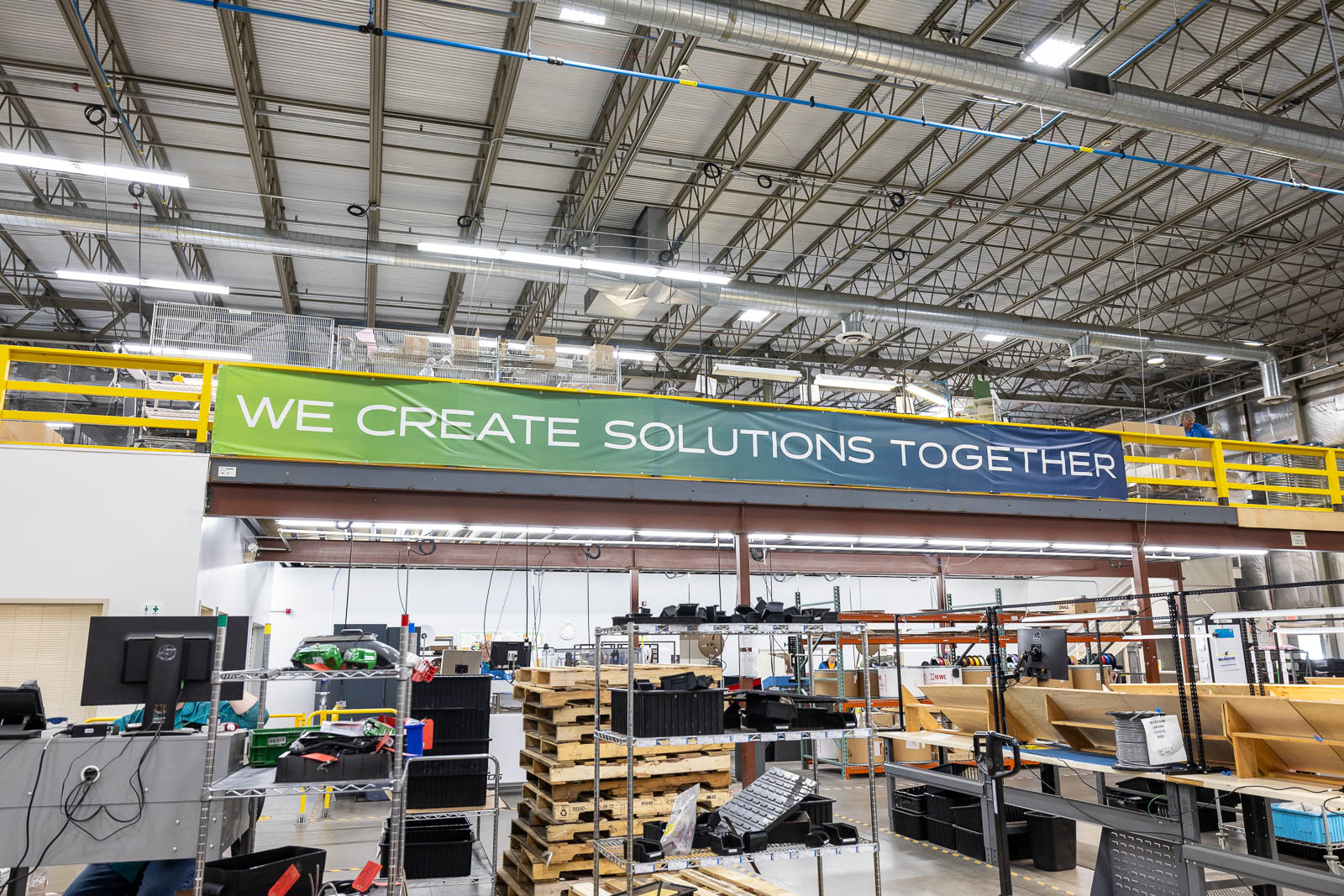 An interior warehouse shot, aimed up at the second story mezzanine with a banner that says