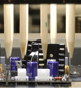 Robotic dispense system adding conformal coating to a PCBA